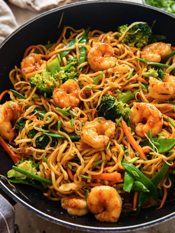 top down view of shrimp with stir fried noodles and vegetables