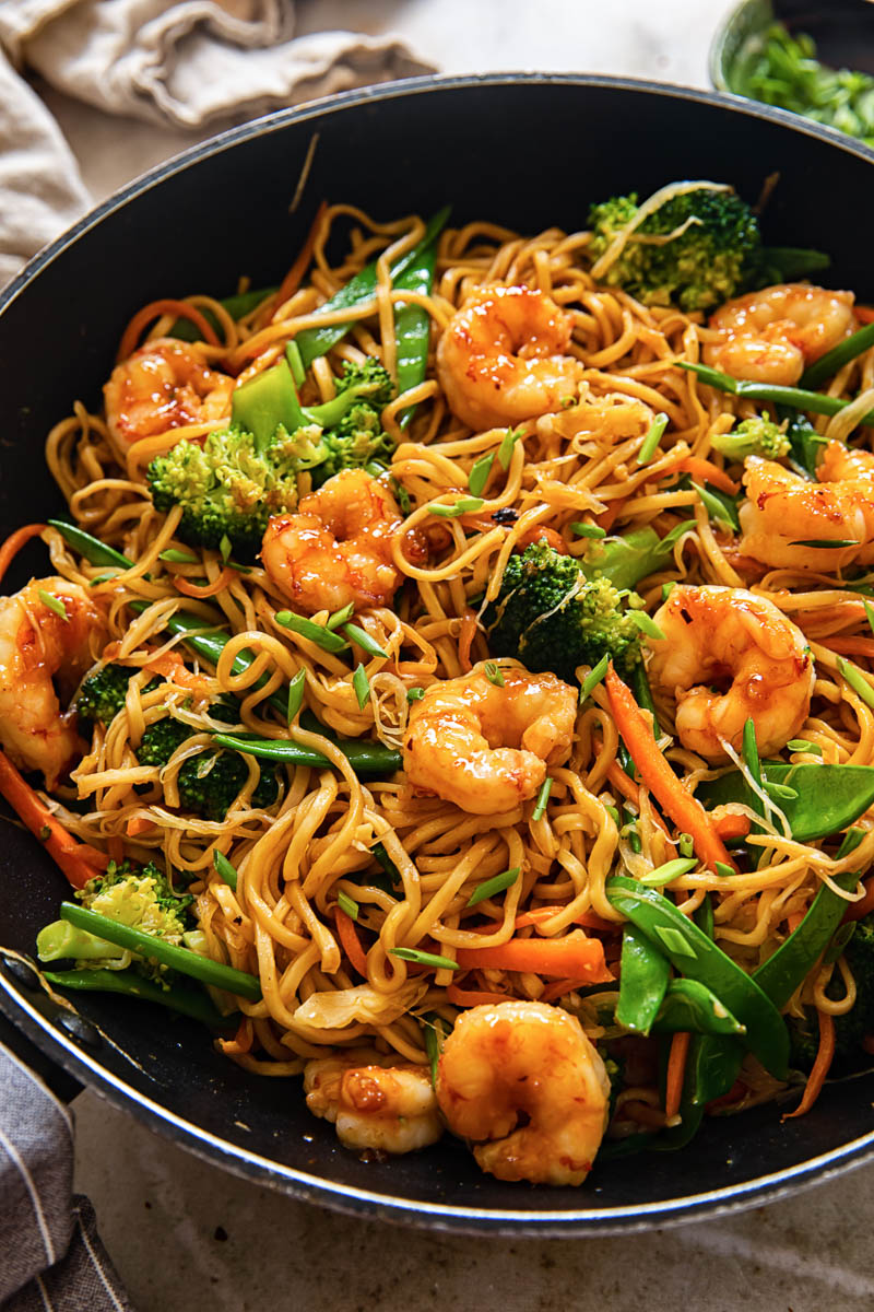 top down view of shrimp with stir fried noodles and vegetables