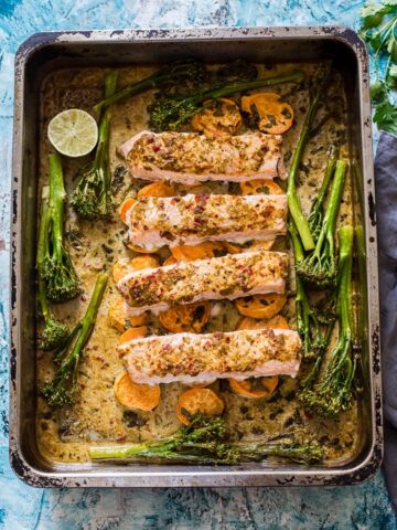 top down view of salmon pieces with broccoli in a roasting pan