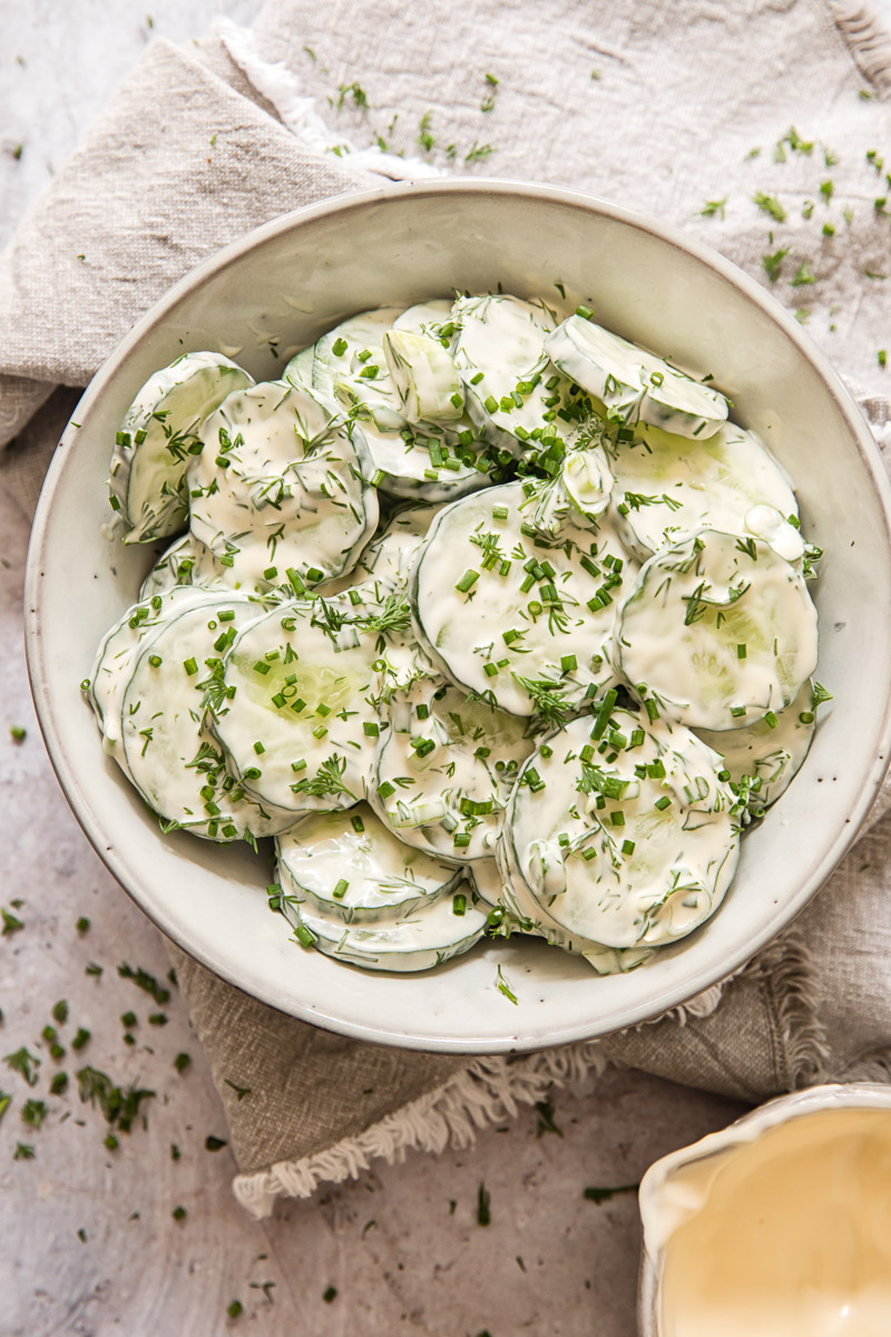 creamy cucumber slices in a grey bowl