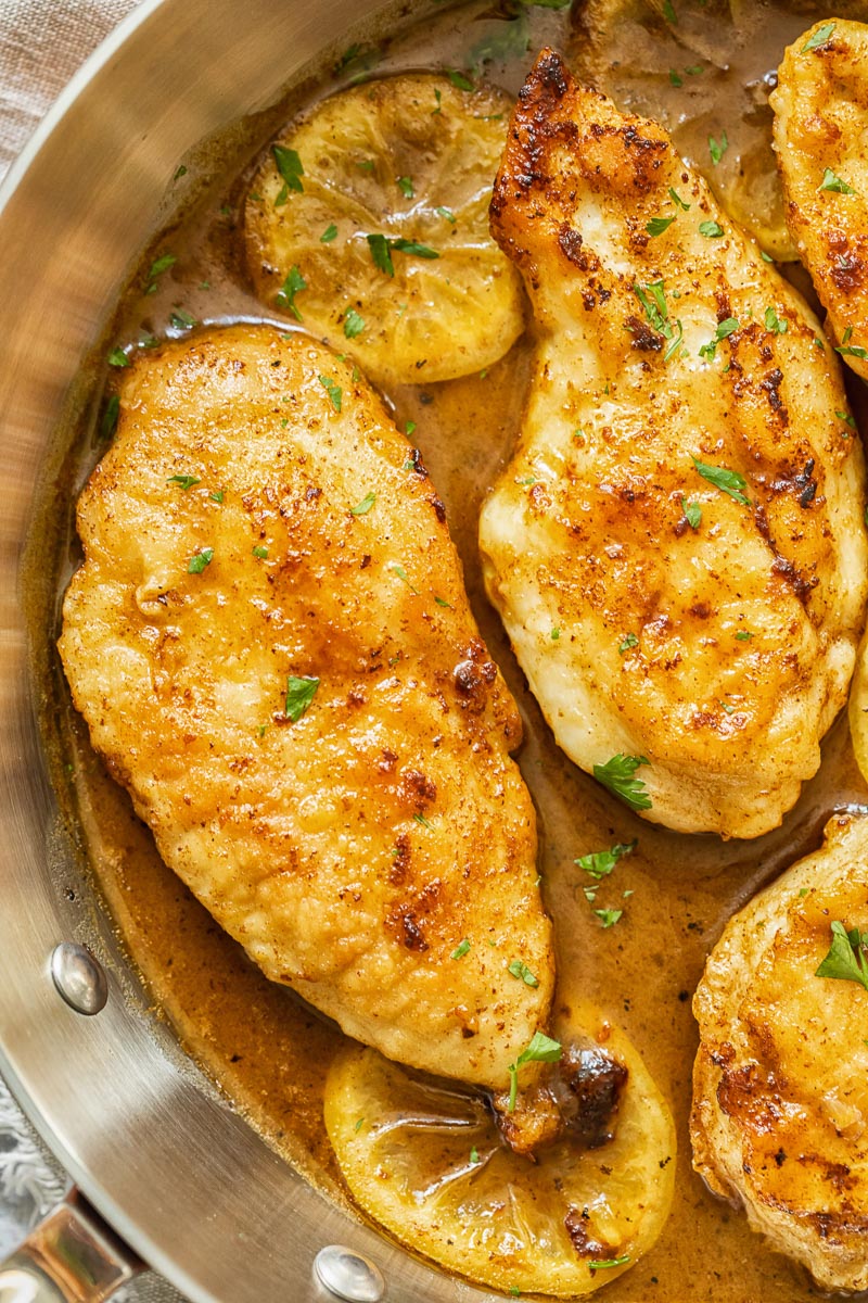 chicken breast in lemon butter sauce in a pan
