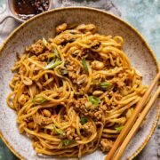 Chinese noodles in a bowl with chopsticks resting on the bowl