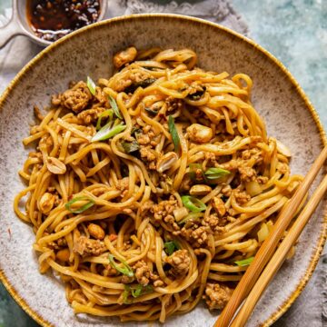 Chinese noodles in a bowl with chopsticks resting on the bowl