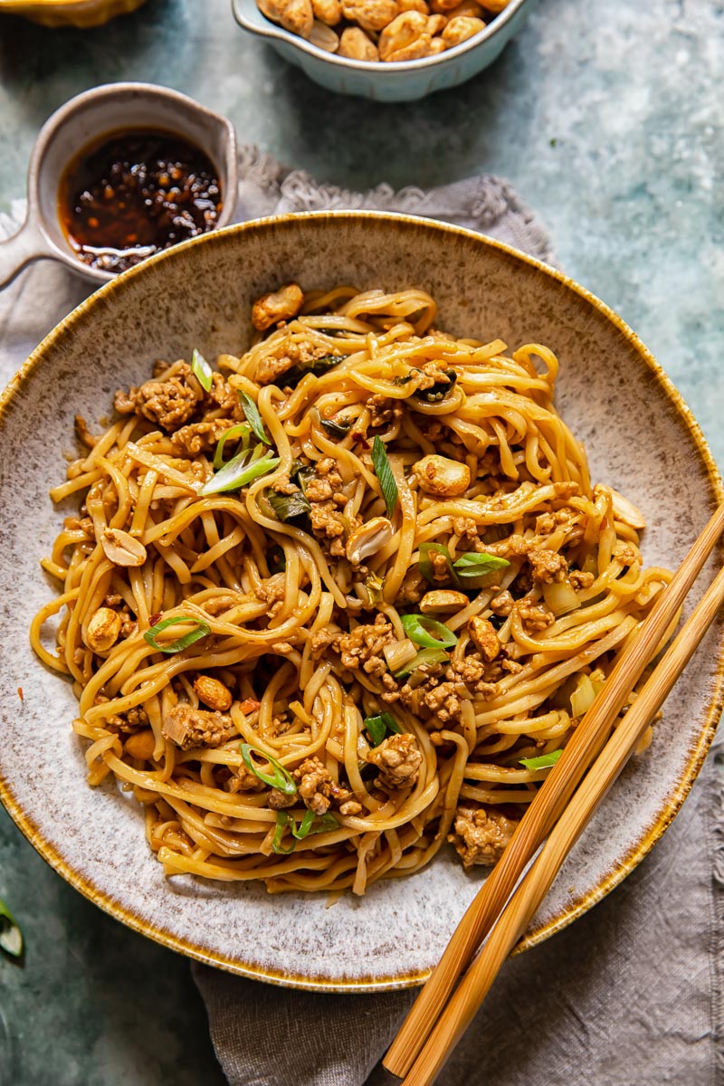 Chinese noodles in a bowl with chopsticks resting on the bowl