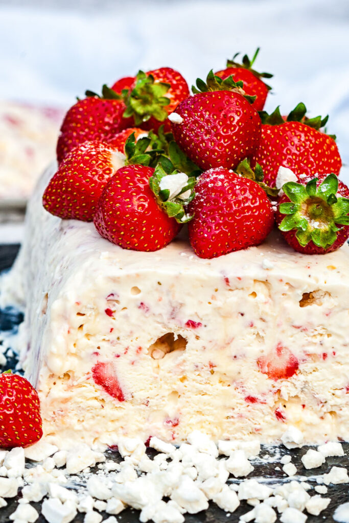 Side view of semifreddo with strawberries on top and inside