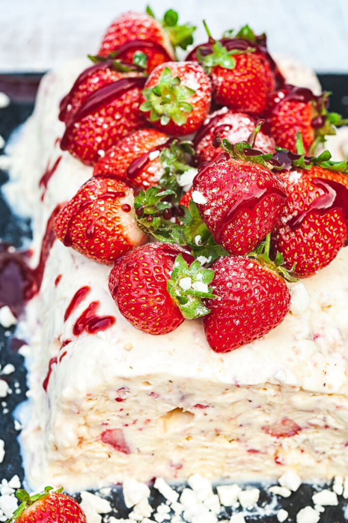 High angle view of semifreddo with strawberries piled on top
