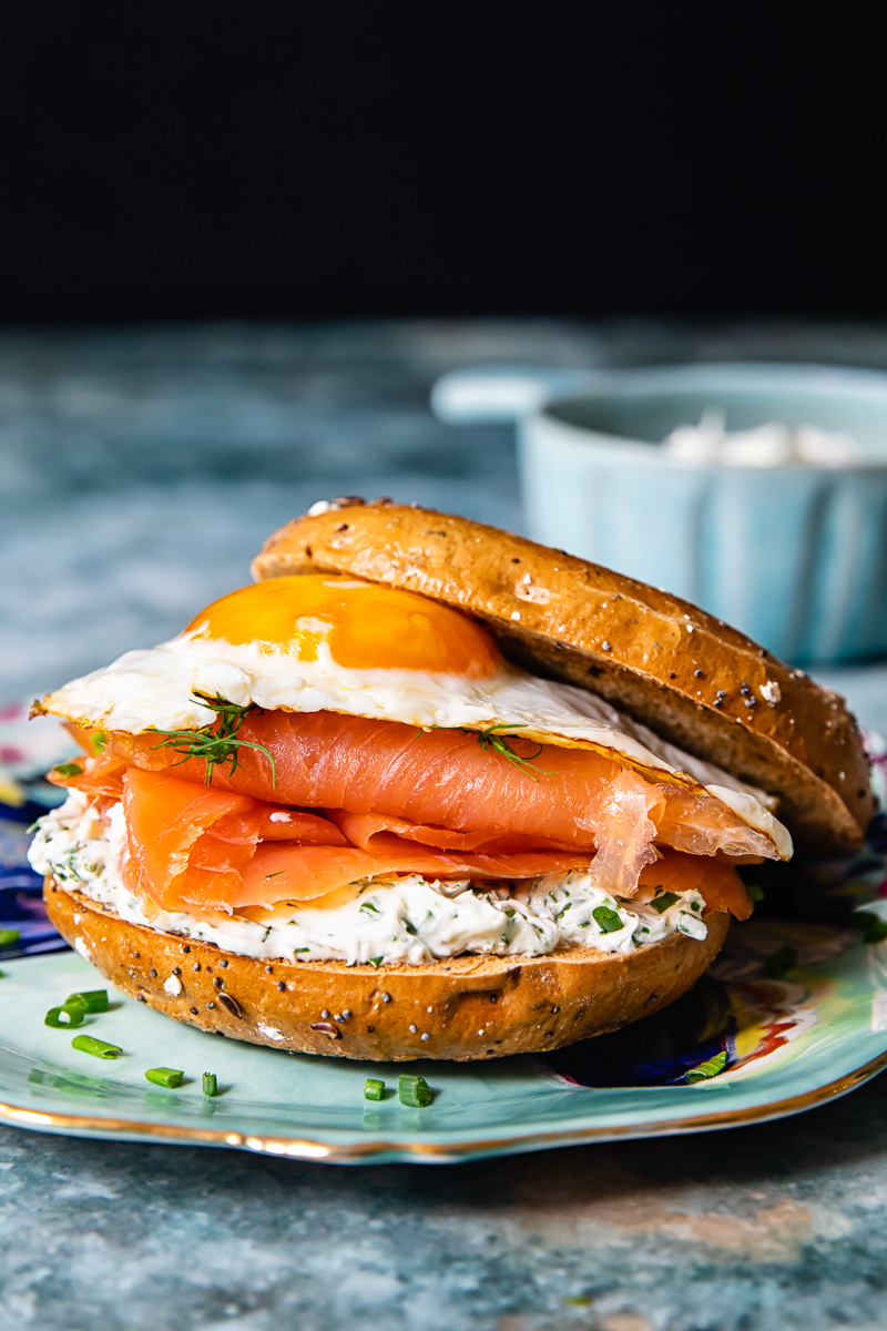 breakfast sandwich with egg and smoked salmon in a bagel