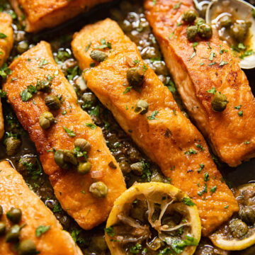 pan seared salmon topped with capers and lemon slices