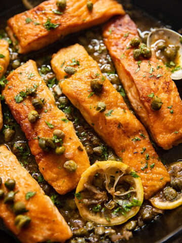 pan seared salmon topped with capers and lemon slices