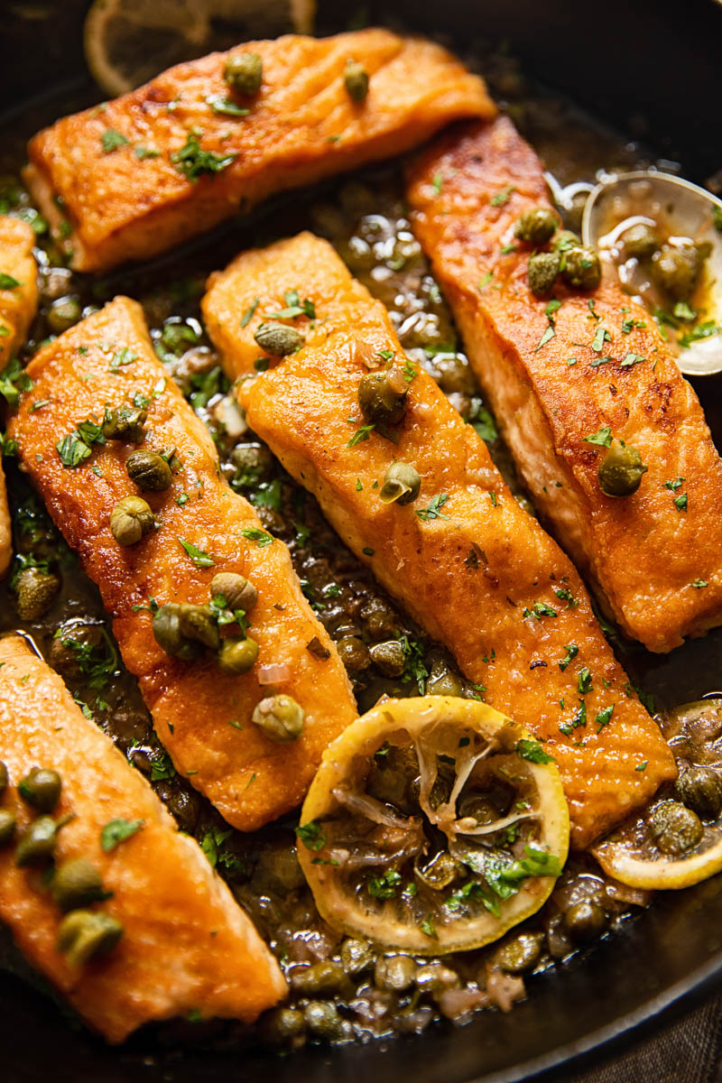 pan seared salmon topped with capers and lemon slices