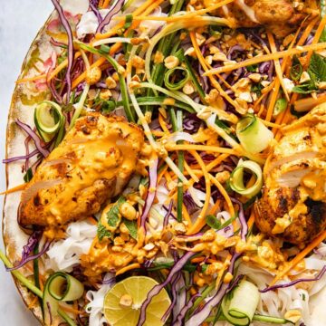 top down view of grilled chicken on top of salad