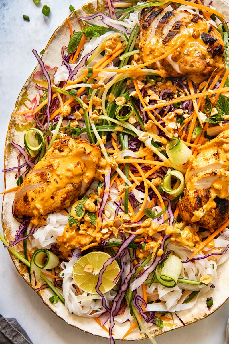 top down view of grilled chicken on top of salad