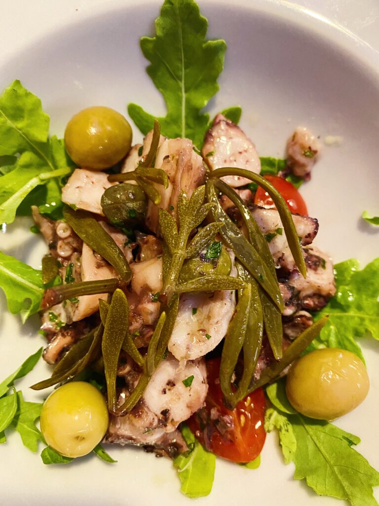 Salad with greens, olives and octopus