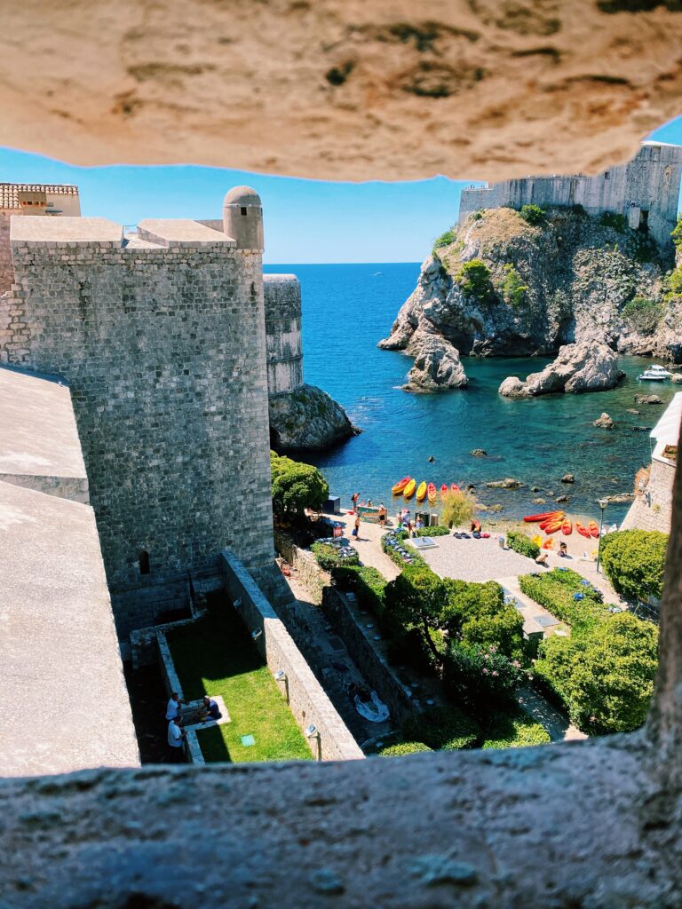 View of a beach framed by a stone window