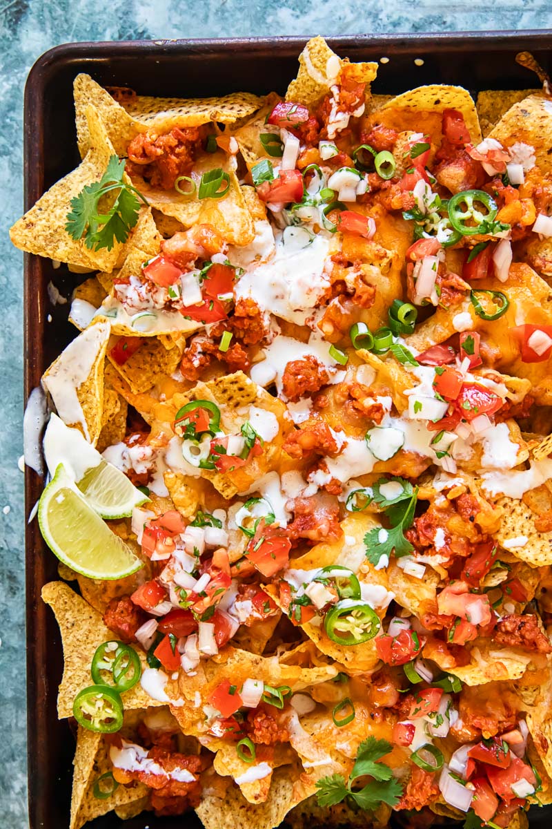 topped down view of nachos supreme in a sheet pan