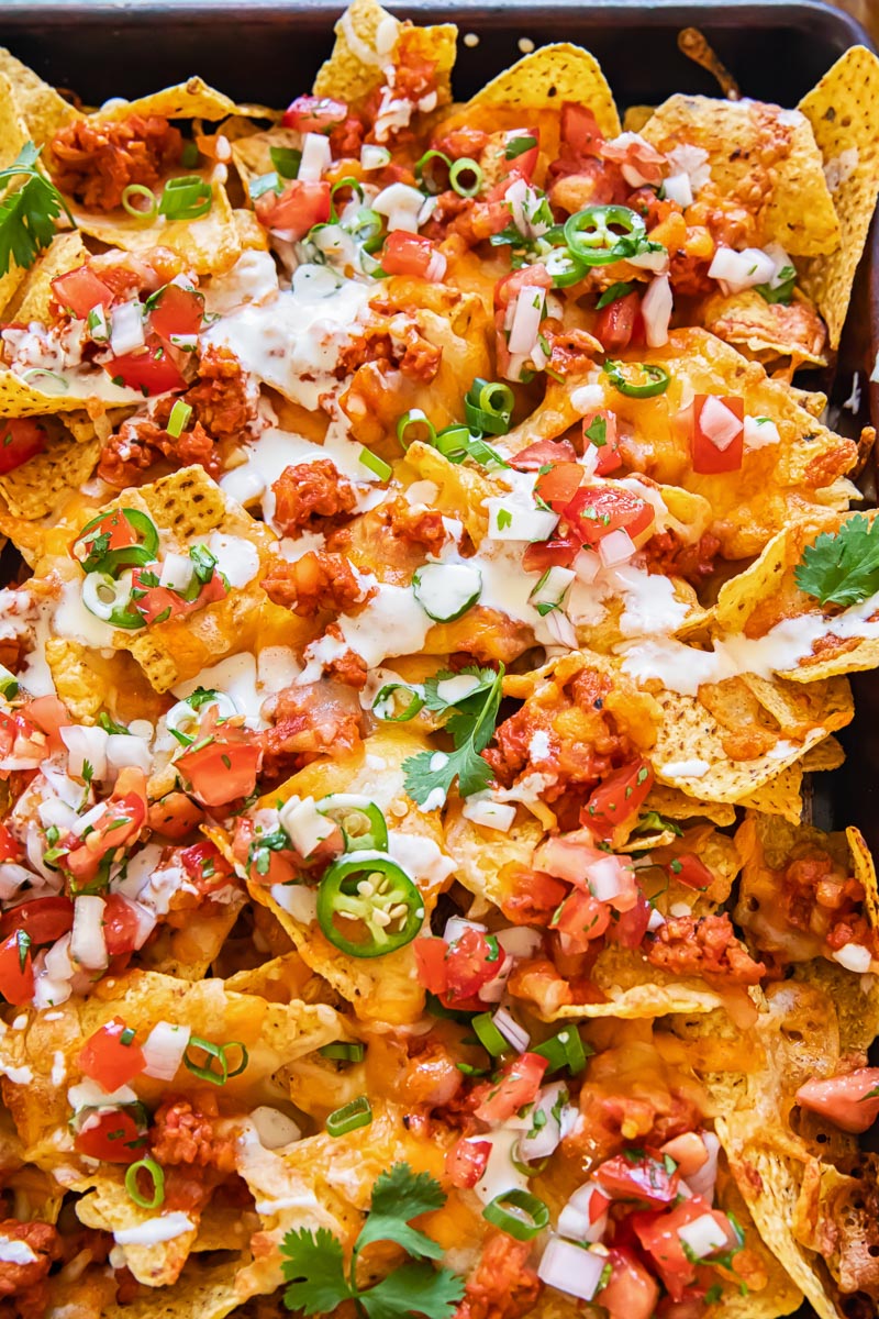 nachos topped with chorizo sausage and pico de gallo