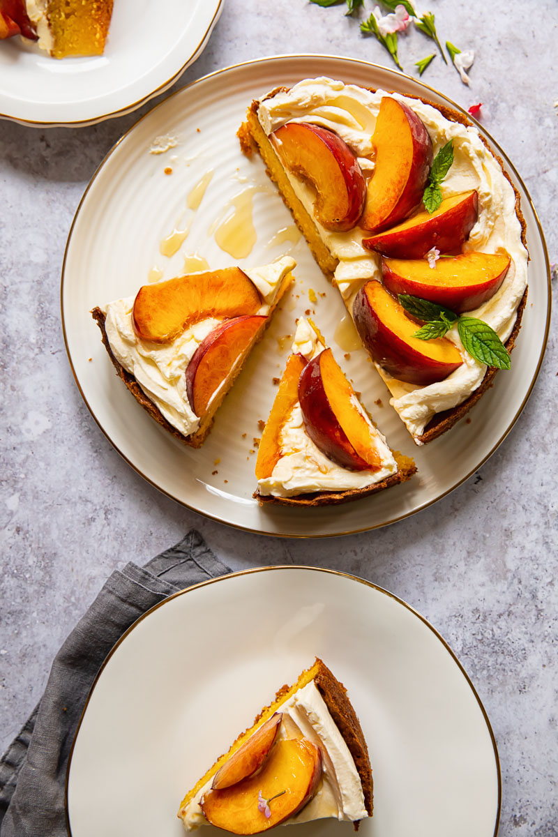 top down view of sliced cake on a platter and a plate with another slice