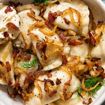 dumplings topped with fried onions and bacon in a bowl