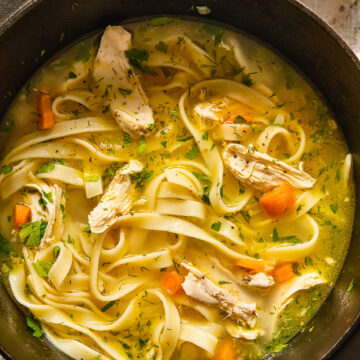 top down view of chicken noodle soup in a pot