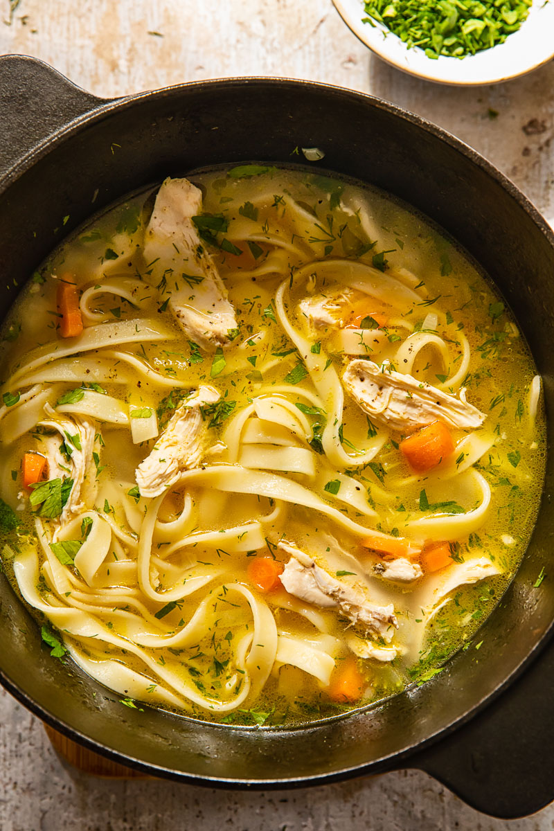 top down view of chicken noodle soup in a pot