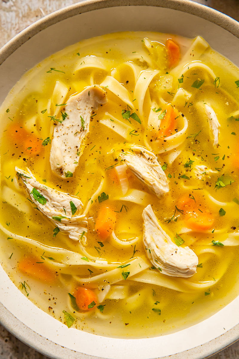 chicken soup in a bowl with noodles and carrots