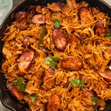 top down view of kielbasa and sauerkraut in a frying pan