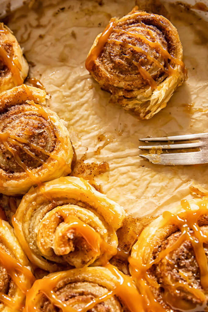 Cinnamon roll removed from others with a fork