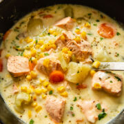 fish chowder in a pot with a ladle inside