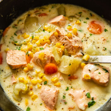 fish chowder in a pot with a ladle inside