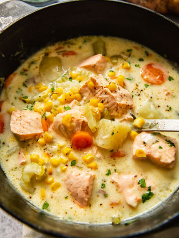 fish chowder in a pot with a ladle inside