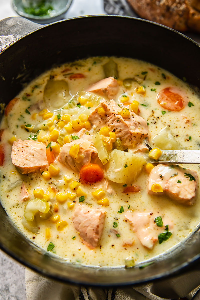 fish chowder in a pot with a ladle inside