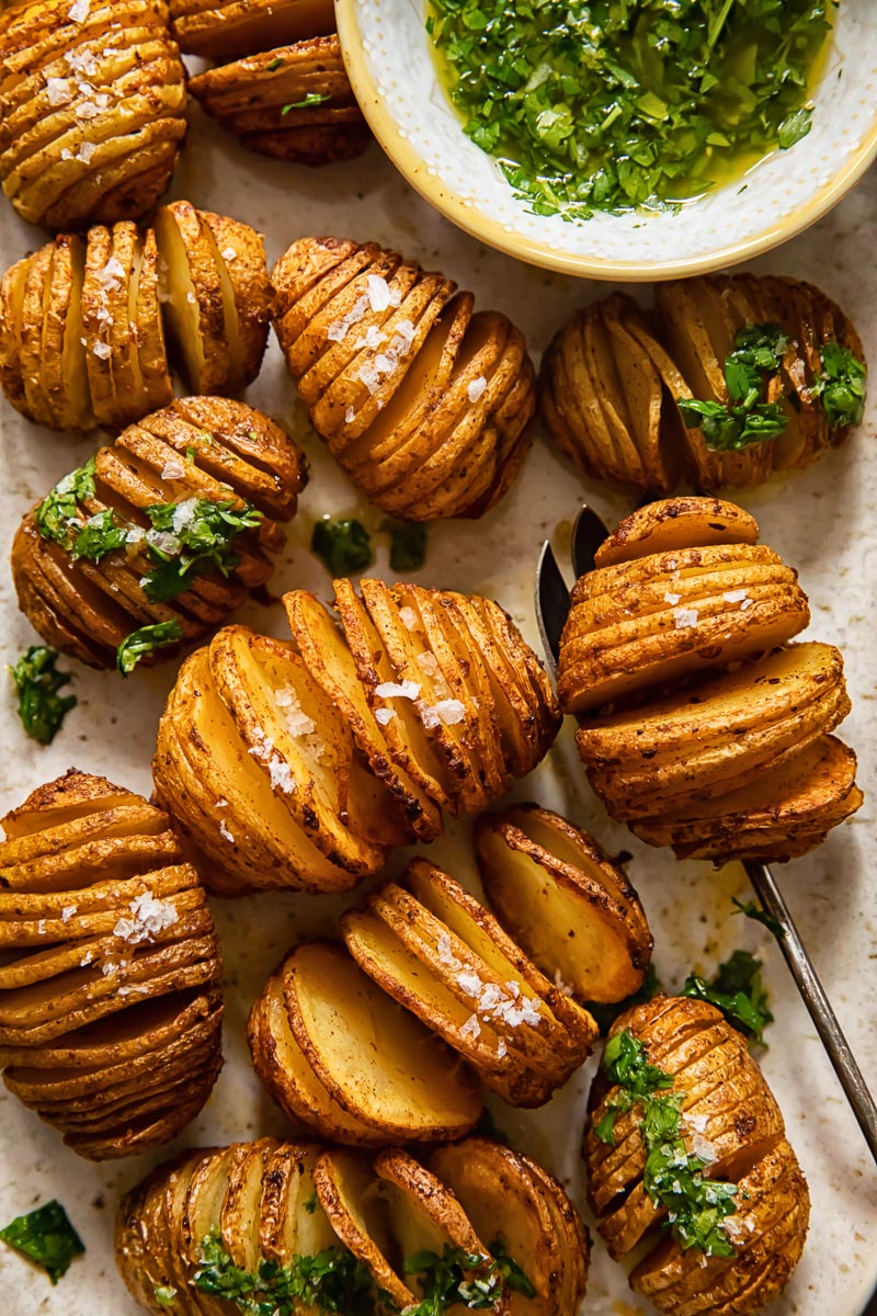 top down view of hasselback potatoes with herb dip