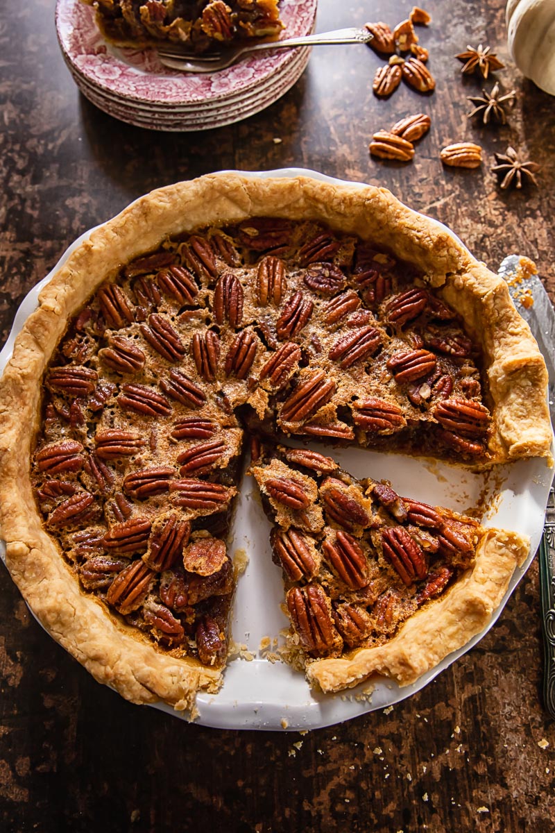 top down view of pecan pie with a slice take out of the pie plate