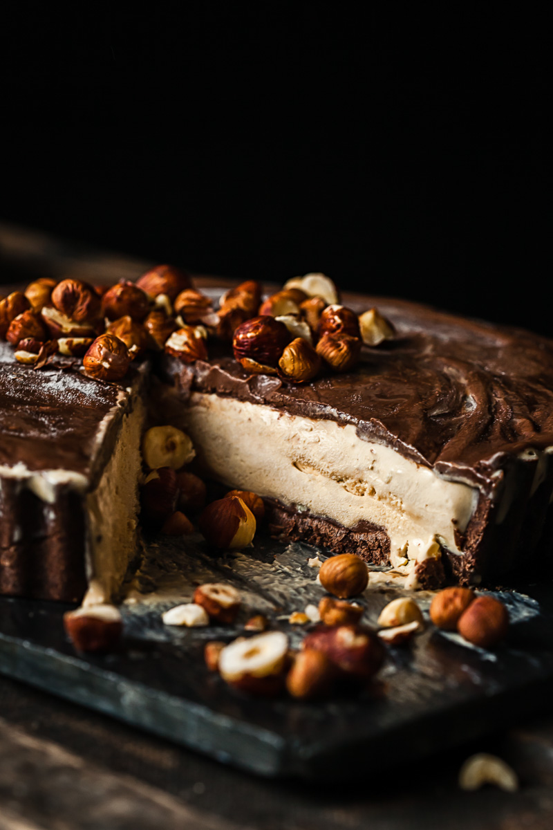 Mud pie with slice removed and nuts scattered