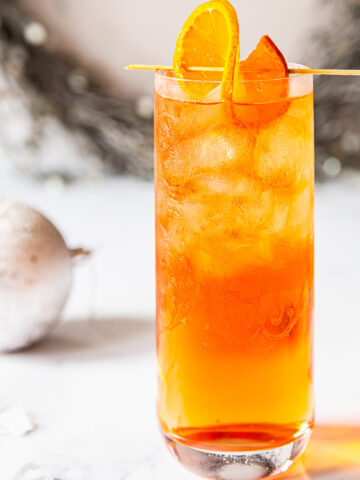 Side view of negroni fizz with orange as garnish