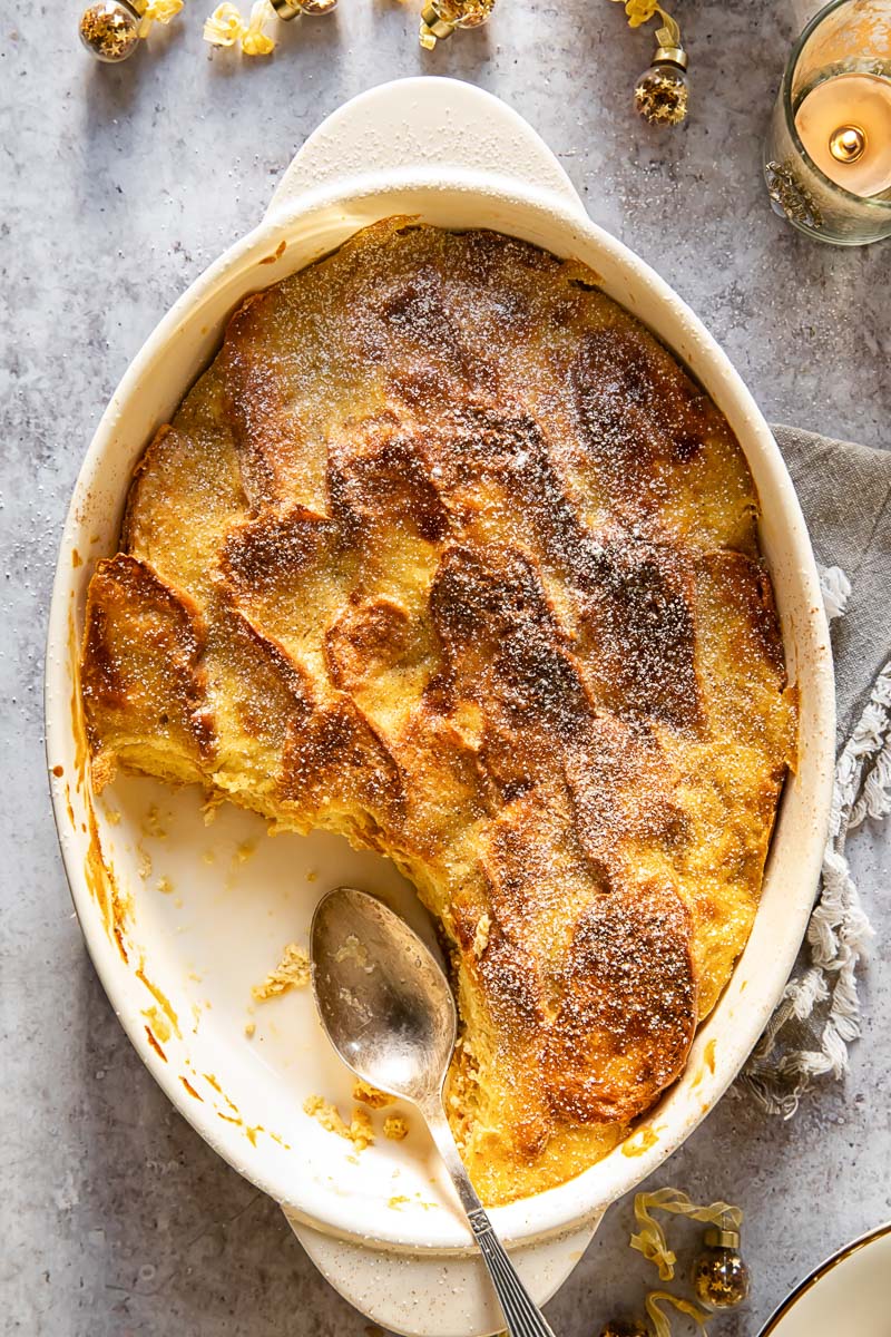 top down view of bread and butter pudding with a spoon in the dish