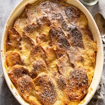 top down view of brioche bread and butter pudding in an oval casserole dish