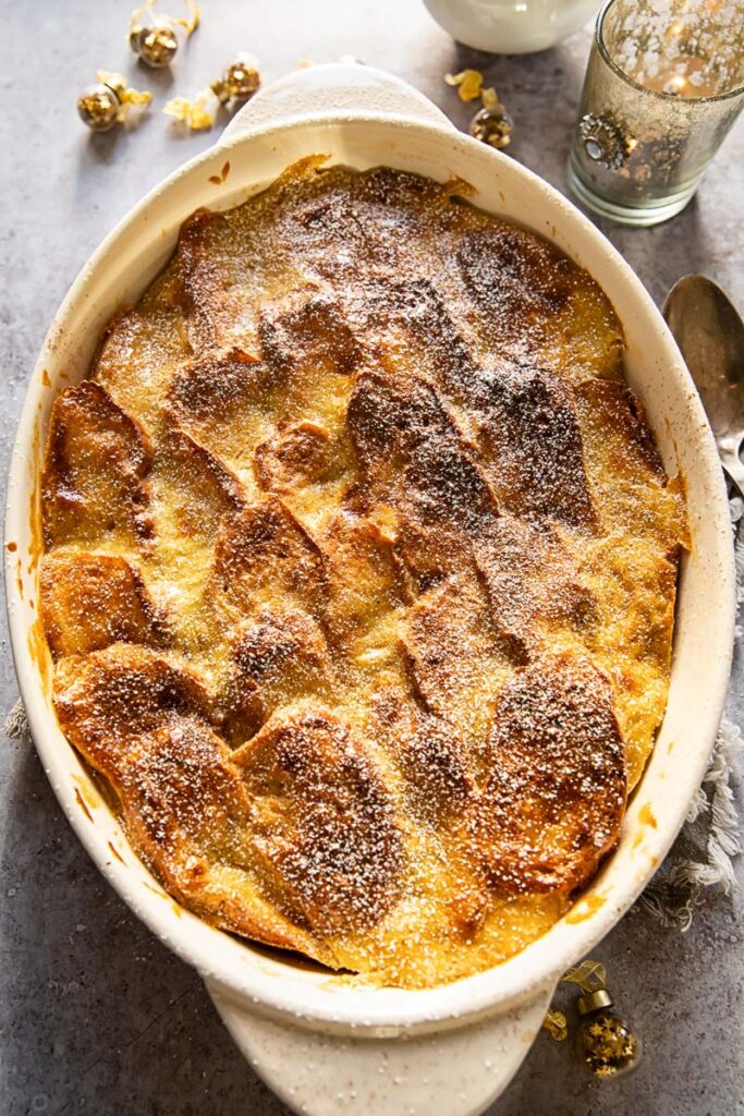 top down view of brioche bread and butter pudding in an oval casserole dish