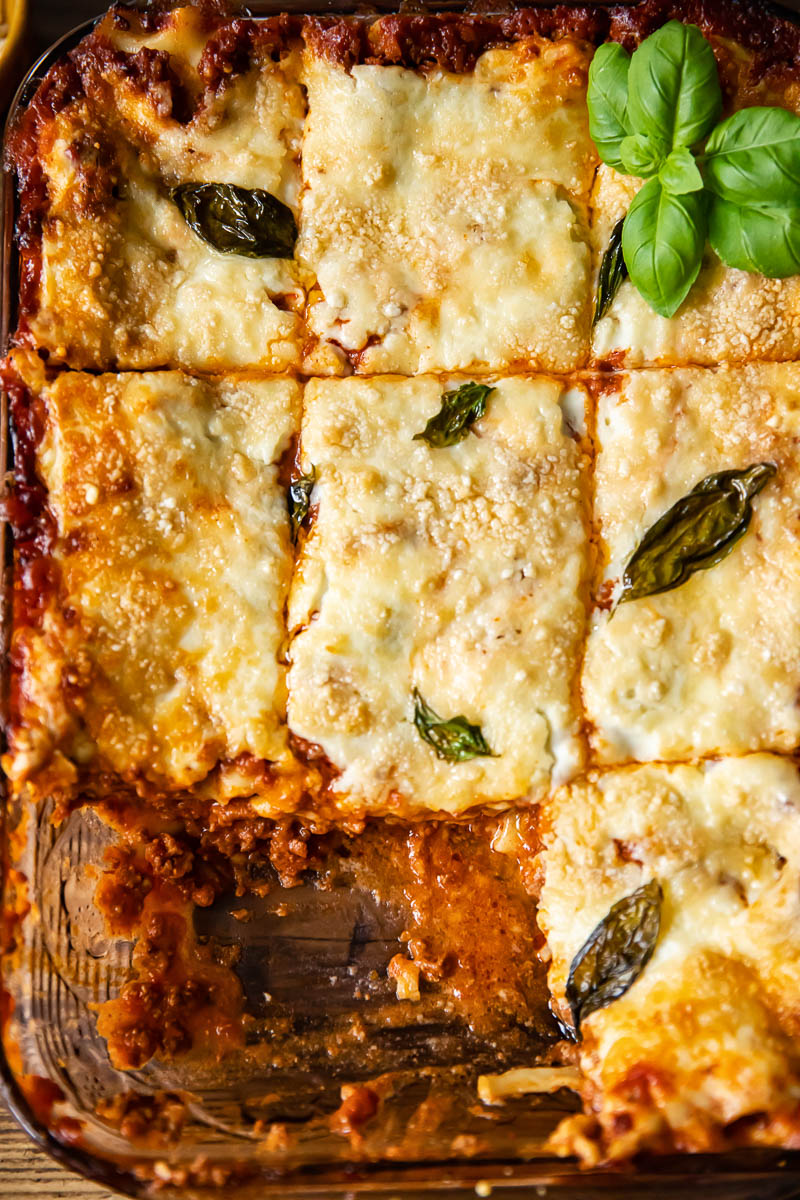 top down view of lasagne in a pan cut into squares