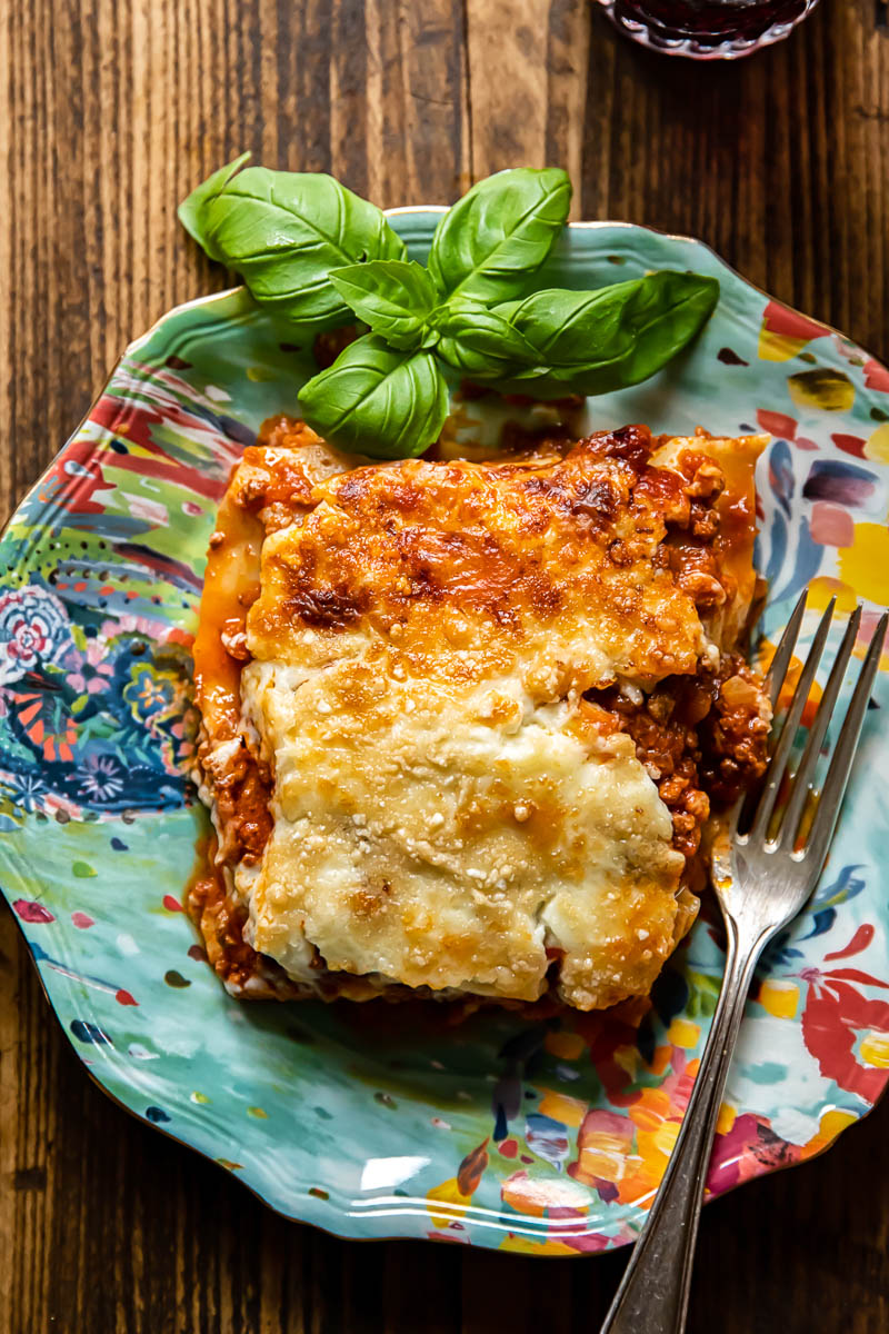 a piece of lasagna on blue plate