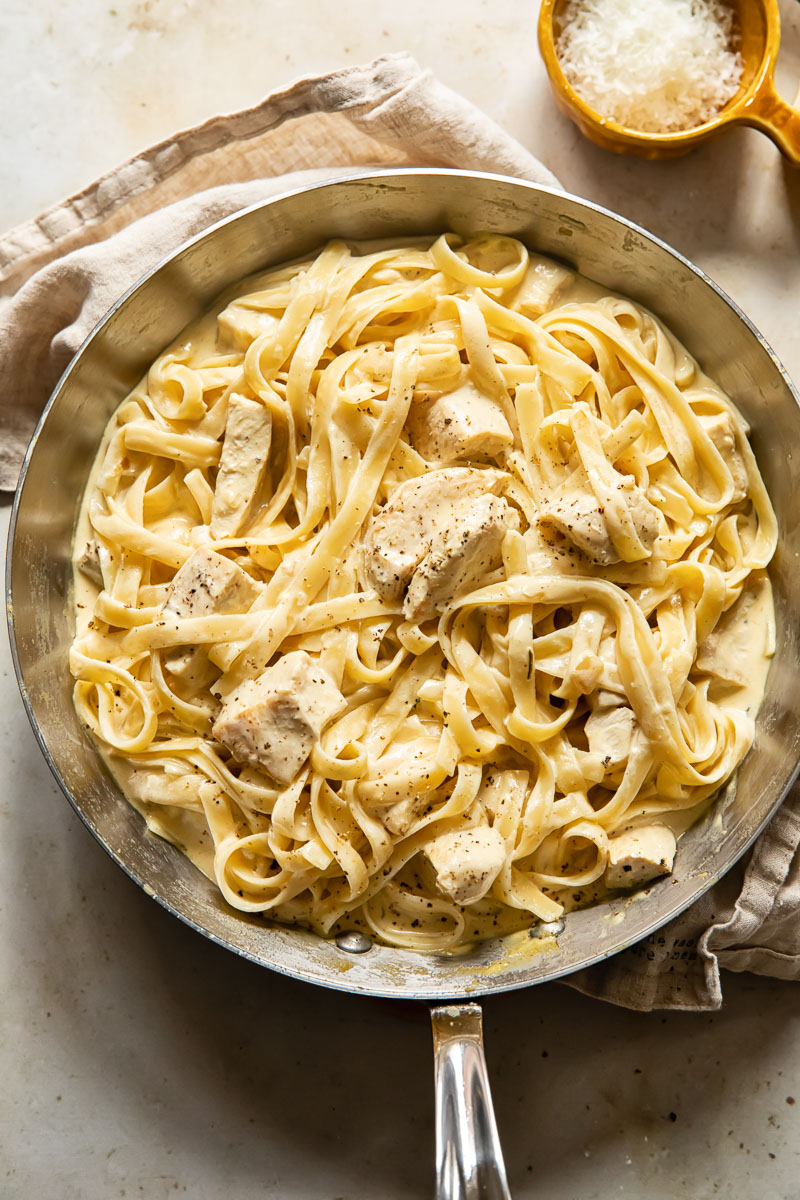 top down view of creamy chicken pasta in a pan