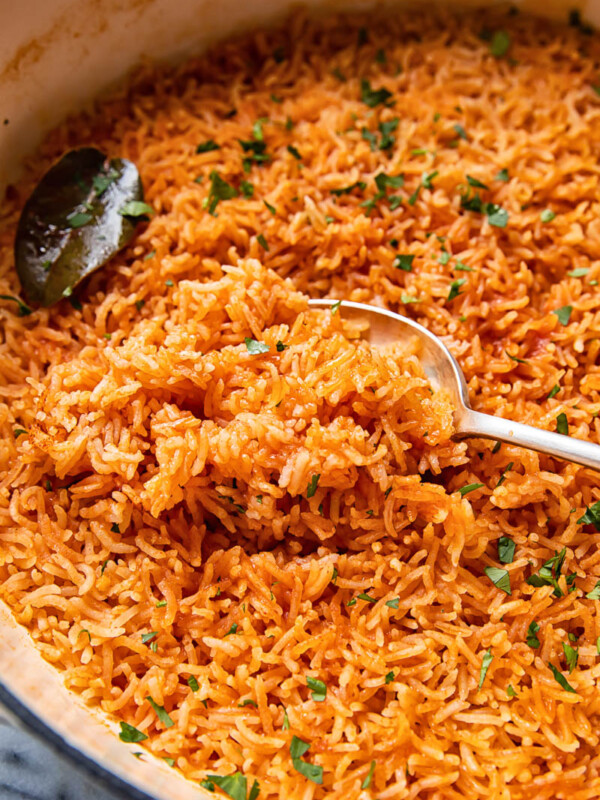 peri peri rice in a pan, scooped with a spoon