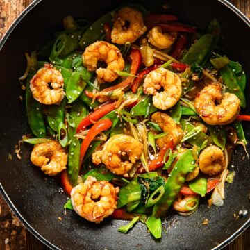 top down view of shrimp stir fried with vegetables in a wok