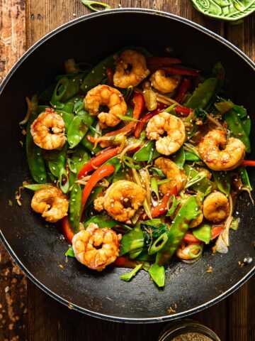 top down view of shrimp stir fried with vegetables in a wok