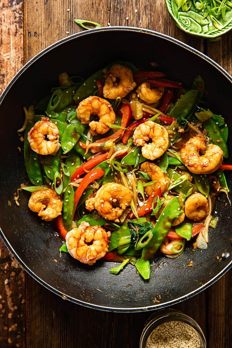 top down view of shrimp stir fried with vegetables in a wok