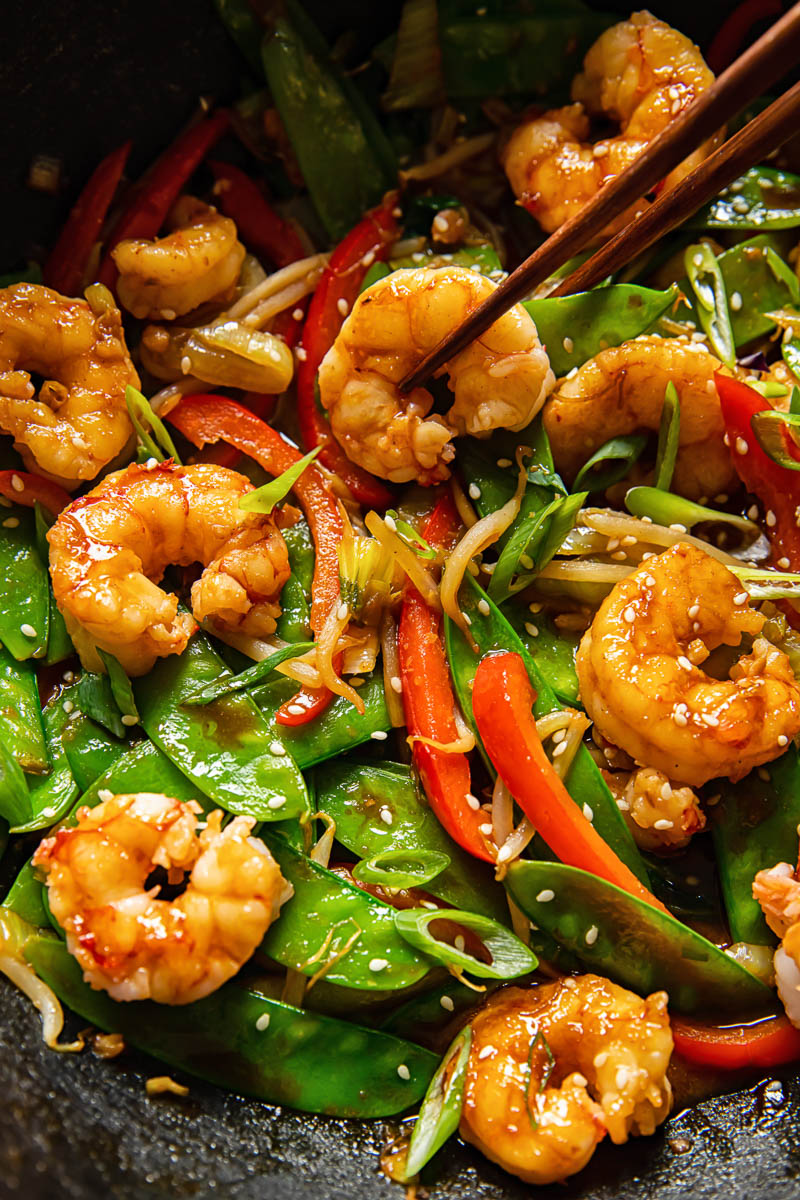 close up of prawn and vegetable stir fry in a wok