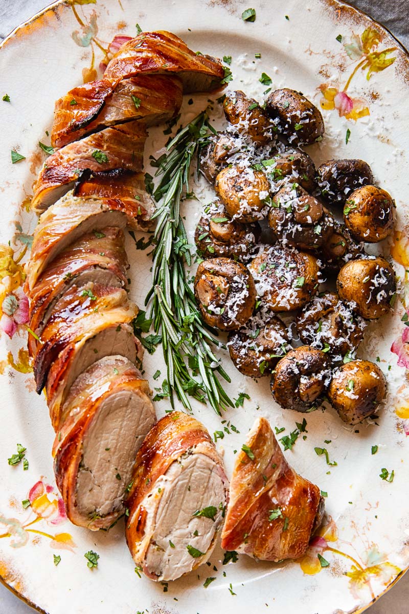 roasted pork tenderloin with fried mushrooms on a platter