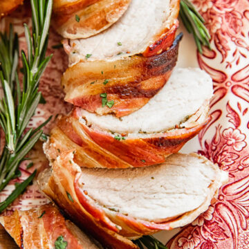 sliced pork tenderloin wrapped in bacon close up
