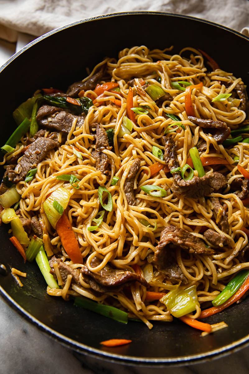 top down view of beef chow mein in a wok