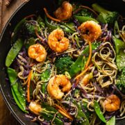 top down view of prawn noodle stir fry in a wok